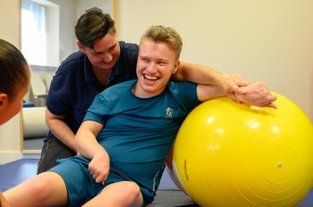 Image shows boy receiving therapy at Cerebral Palsy Scotland