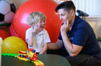 Image shows child receiving therapy at Cerebral Palsy Scotland. 
